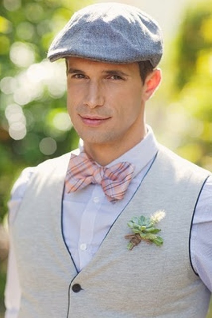 a vintage groom's look with a white shirt, a neutral waistcoat, a grey cap and a printed bow tie