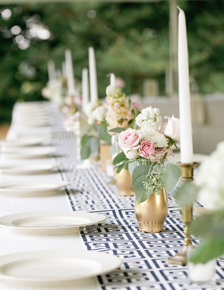 White and blue patterned table runner with tall taper candles