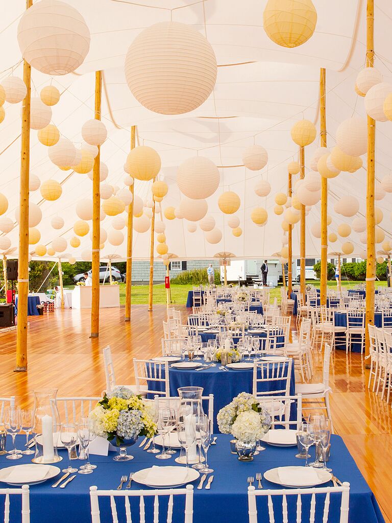 Tented wedding reception with white and yellow paper lanterns