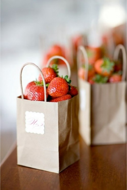 fresh strawberry in paper bags is a great summer wedding or rehearsal dinner favor idea