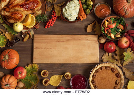 Autumn festive Thanksgiving dinner background with Turkey and traditional sides dishes around Wooden Board, copy space for text, menu design, seasonal - Stock Image