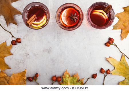 Hot red tea with lemon on light gray table with copy space viewed from above, delicious autumn mulled wine drink - Stock Image