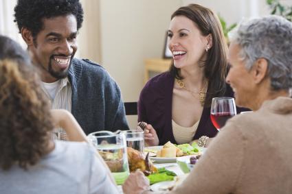 Family talking and enjoying Thanksgiving dinner 