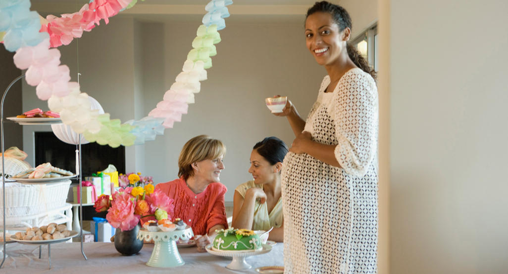 pregnant woman smiling at party with others in the background