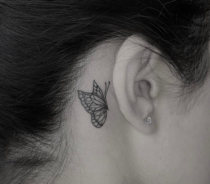 butterfly tattoo under ear