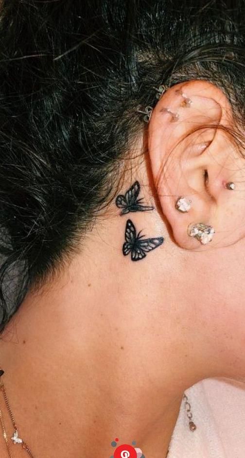 red butterfly tattoo behind ear