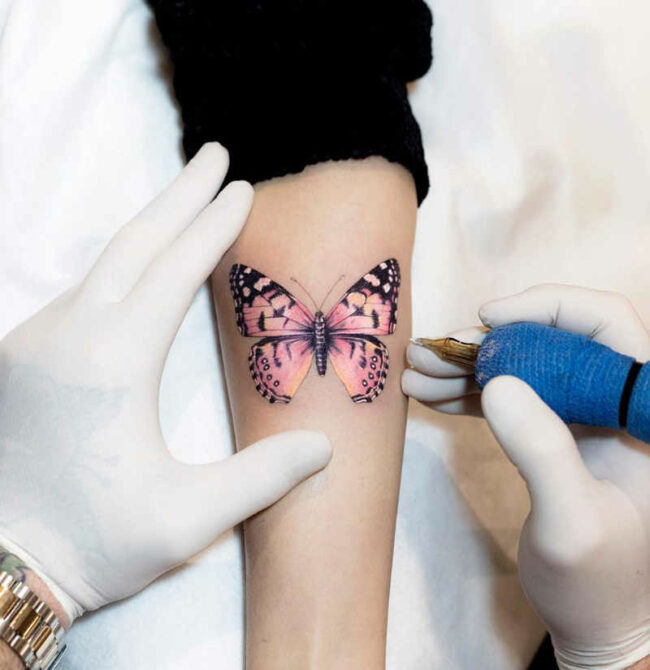 butterfly tattoo on arm to hand