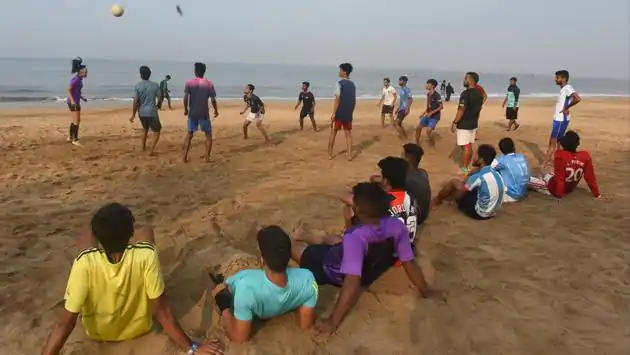 People watch a game of football being played at Juhu Beach in Mumbai on December 1. A rise in infections in the Maharshtra capital without a sharp spike, suggests the Covid-19 situation is in control post Diwali, according to Brihanmumbai Municipal Corporation (BMC) officials, HT reported. There remains however, a need to monitor it till mid-December. (Vijayanand Gupta / HT Photo)