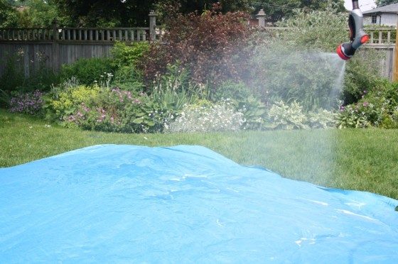 hang hose over clothes line for homemade water slide