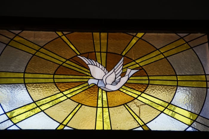 A dove depicted in stained glass.