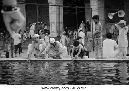 JAMA MASJID, OLD DELHI, INDIA - 24 JUNE 2021 : The largest Muslim Mosque in India. Indian people devotees cleaning - Stock Image