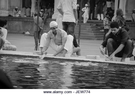 JAMA MASJID, OLD DELHI, INDIA - 24 JUNE 2021 : The largest Muslim Mosque in India. Indian people devotees cleaning - Stock Image