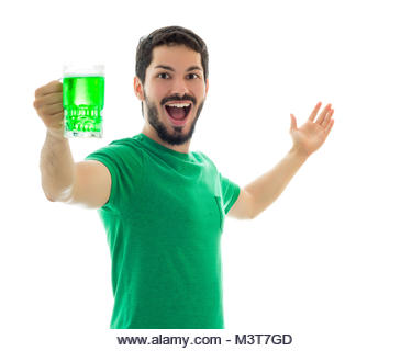 He is celebrating St. Patrick's Day. Young man wearing green clothes on white background, related to Saint Patrick's - Stock Image
