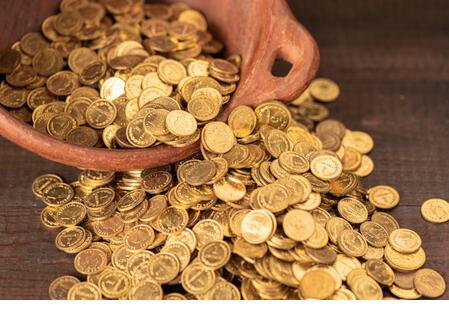 Cascade of small golden coins from a terracotta pot - Stock Image