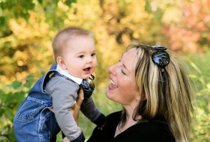 mother holding up baby boy and looking at him lovingly for mothers day