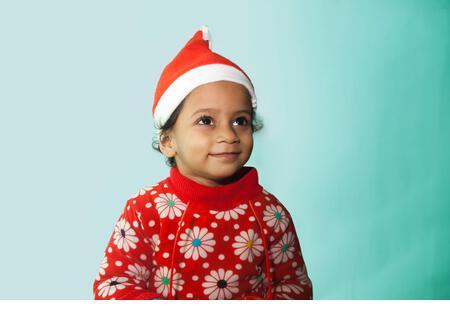 Smiling Little girl in santa hat, Christmas - Stock Image