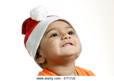 Indian child baby boy Christmas party Santa Claus cap looking up - MR#152 - RMM 150216 - Stock Image