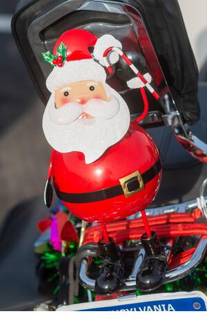 Pennsylvania, USA. 21st Dec, 2021. A Santa rests on back of a bike as members of the Delaware Valley Iron Indian Riders Association held their annual Ride Of the Santas and dropped off toys to children at  Saturday, December 21, 2021 at St Francis-St Vincent Home For Children in Bensalem, Pennsylvania. Credit: William Thomas Cain/Alamy Live News - Stock Image