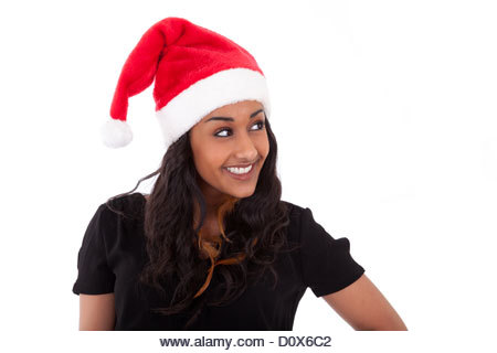 Young African American woman wearing a santa hat, isolated on white background - Stock Image