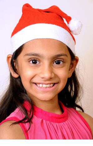 Mumbai, Maharashtra, India- Asia, Dec. 29, 2014 - Happy Indian two little cute girls red Santa Claus Hat Celebrating Christmas festival smiling face. - Stock Image