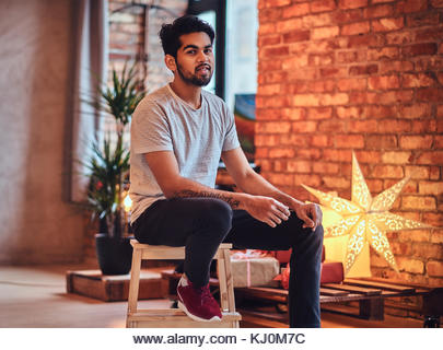 Indian male in the loft room. - Stock Image