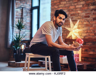 Indian male in the loft room. - Stock Image