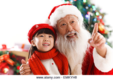 Santa Claus and the little girl for Christmas - Stock Image