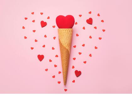 Happy Valentine's Day.Red heart in ice cream cone on a pink background.Valentine day concept - Stock Image