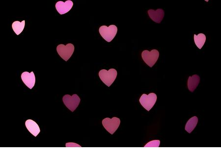 Valentines background. Abstract heart bokeh background. Defocused blurred heart shaped lights.  Love concept. - Stock Image