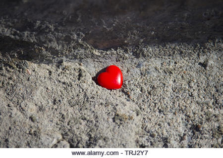 Red heart on concrete background. Valentines day concept - Stock Image
