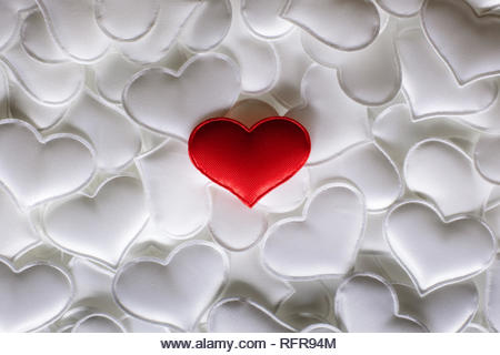 Red textile heart on white hearts background. Valentines day texture and love concept - Stock Image