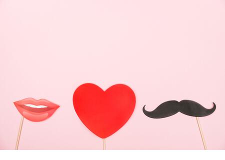Valentine's day, love, romantic concept. Red heart, mustaches and lips paper prop on pink background. Greeting card. Flat lay, top view, copy space. - Stock Image
