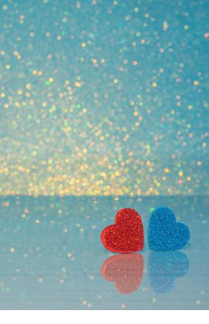 Valentines background. Red and blue Heart on table with reflection on it.  Valentine day love concept. Lovely photo. - Stock Image