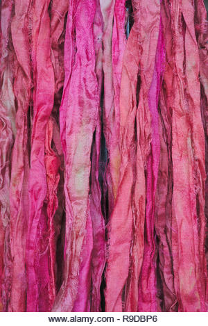 Pink silk ribbons background. Texture. Close-up shot, macro photography. - Stock Image