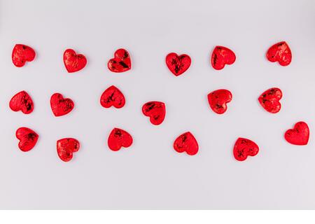 a background of red hearts on a white background for the feast of lovers Valentine's day February 14 - Stock Image