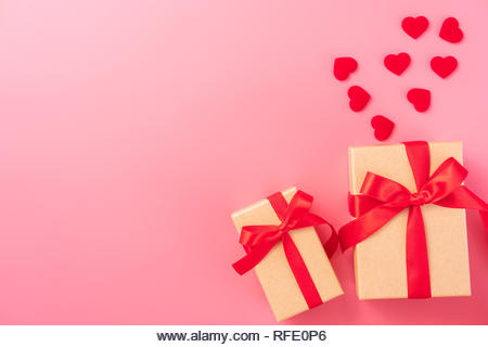 Giving present and celebration concept at Valentine's day, anniversary, mother's day and birthday surprise on pink background, copyspace, topview - Stock Image