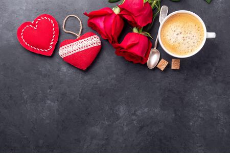 Valentines day greeting card. Coffee cup, red roses and textile hearts on stone background. Top view - Image - Stock Image