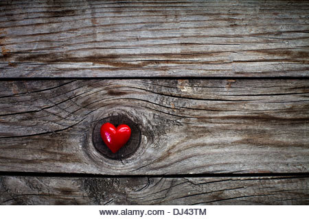 Valentines Day background with heart on wooden desk - Stock Image
