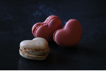 heart-shaped macaroons on dark background. Macaroons Heart. Valentine's Day. - Stock Image