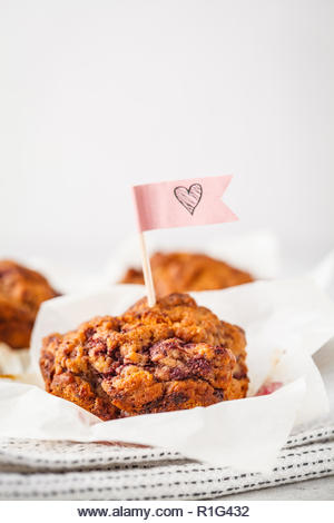 Vegan berry muffins on a white background, Valentine's Day food. - Stock Image