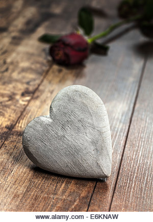 Valentine's day symbol. Heart on a wooden background with red rose. - Stock Image