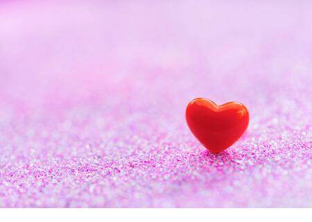 Valentines Day background with Red heart shapes on abstract light pink glitter background, Copy space - Stock Image