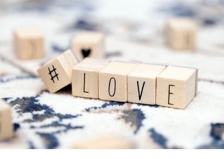 Wooden cubes with a hashtag and the word Love, social media and valentines concept background - Stock Image