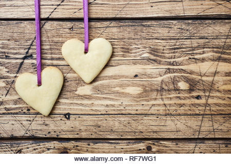 Heart shaped cookies for valentine's day on wooden background. Copy space. - Stock Image
