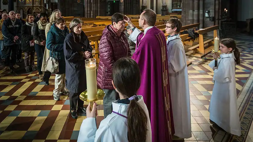 Worshippers in church lining up on Ash Wednesday