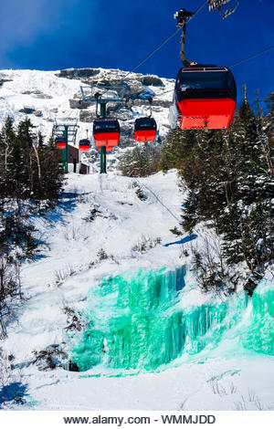 Stowe, Vermont, USA - Mar 17, 2005 The gondola lift over a green frozen waterfall dyed in honor of St. Pattys Day - Stock Image
