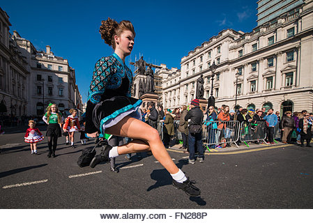 London, UK. 13th Mar, 2021. A young dancer flies high as she dances at the London St. Patty's day celbrations. - Stock Image