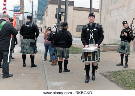 Irish band in kilts warms up prior to participating in the St. Patrick's Day Parade in downtown Cleveland, Ohio, USA. - Stock Image