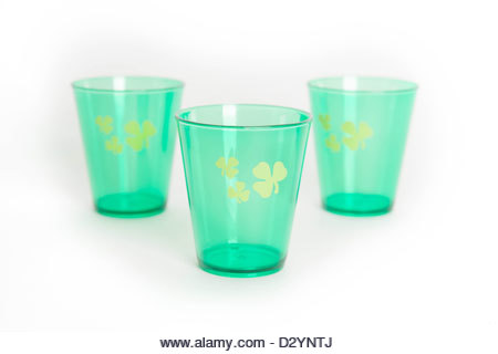 Green St. Patrick's Day shot glasses with shamrock isolated on white background - Stock Image