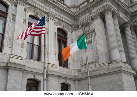 Irish and American flags flying side by side on St Patrick's Day - Stock Image